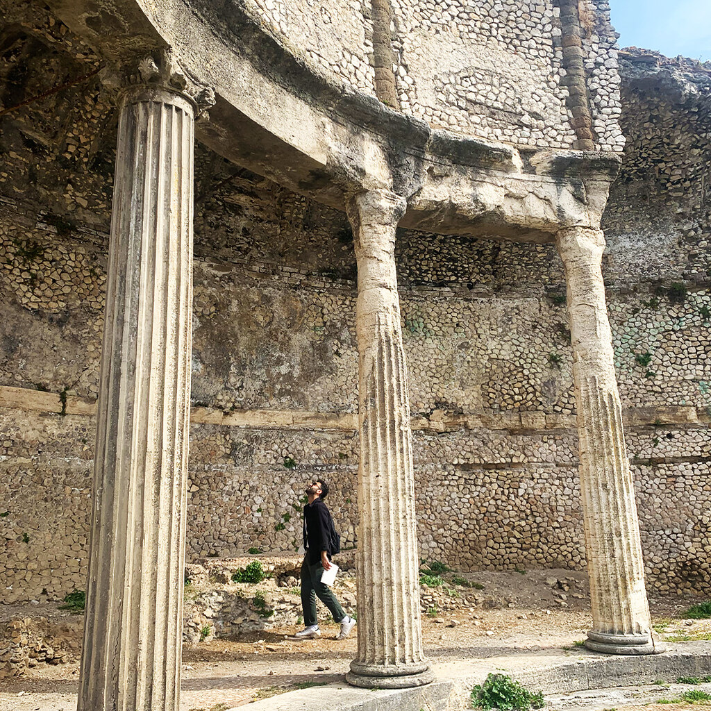 student walking through architectural ruins