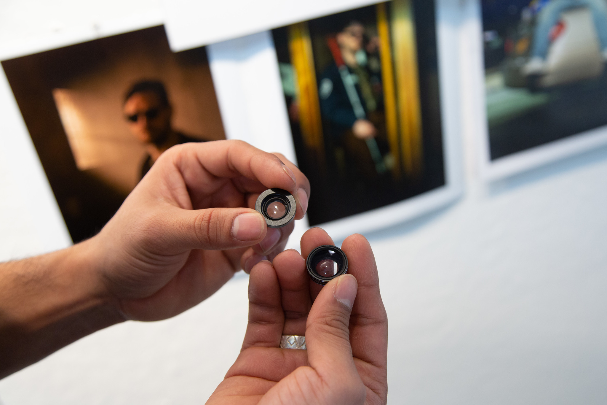 hands holding small lenses