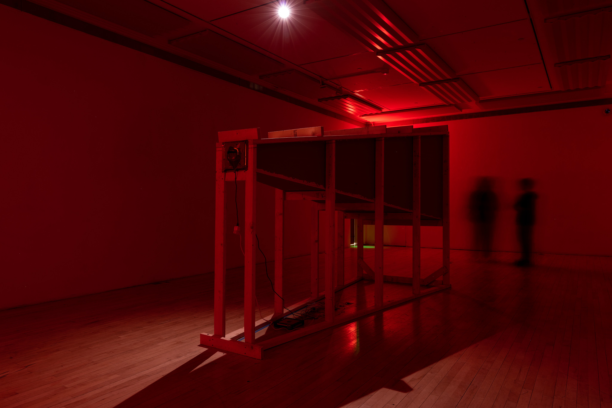 large red-lit wooden sculpture