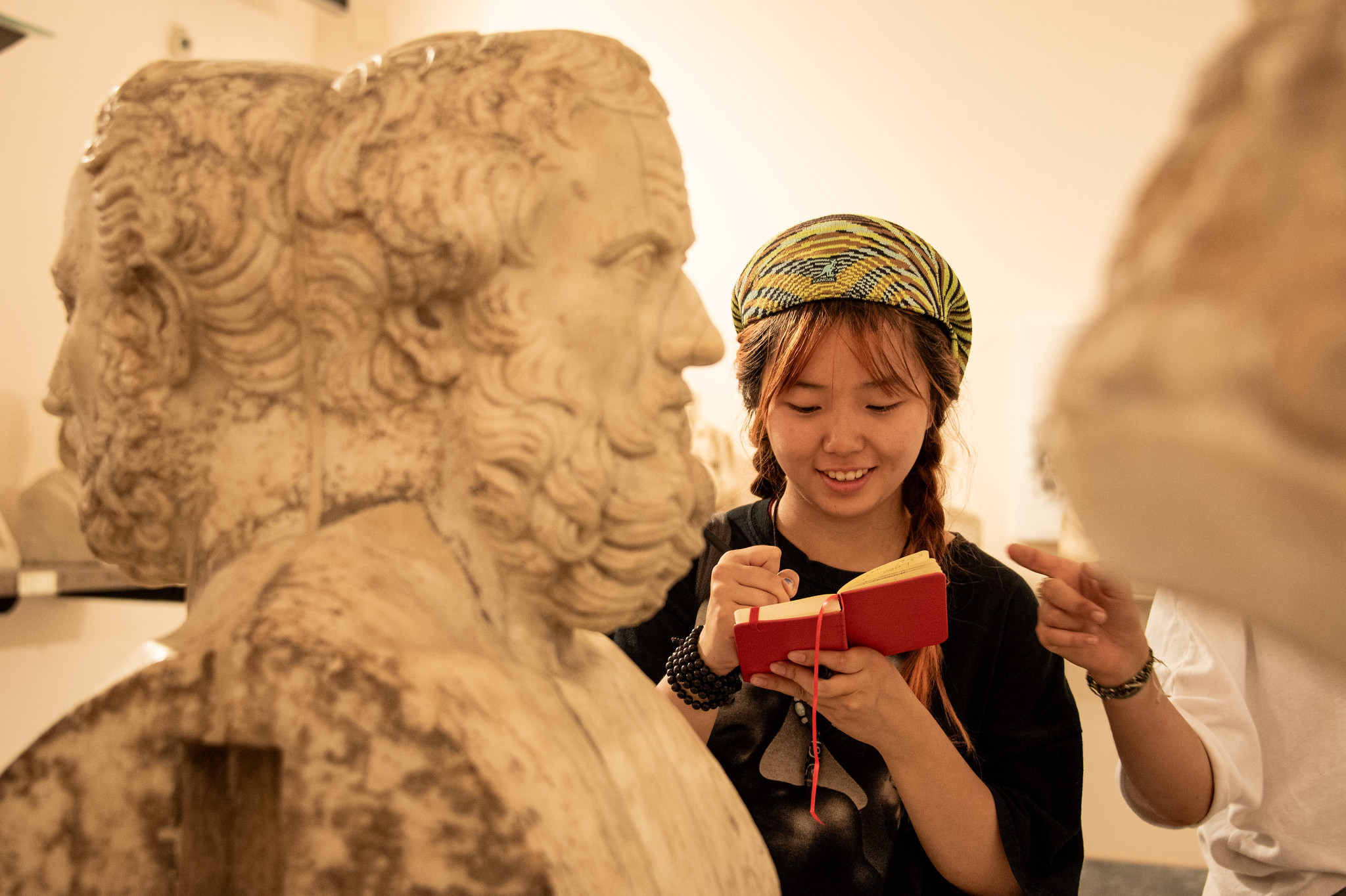 student sketching a marble bust