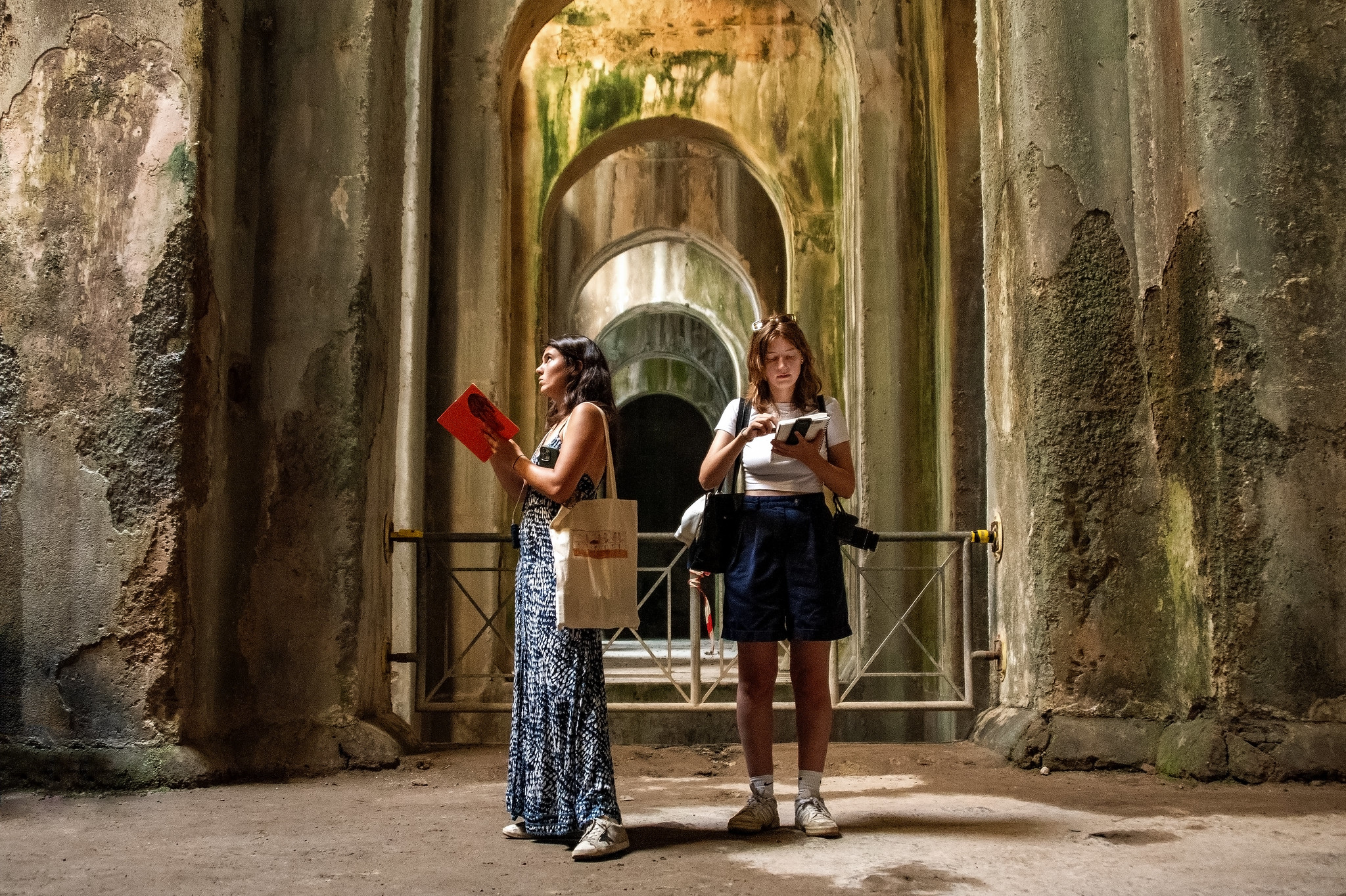 students sketching in a stone tunnel