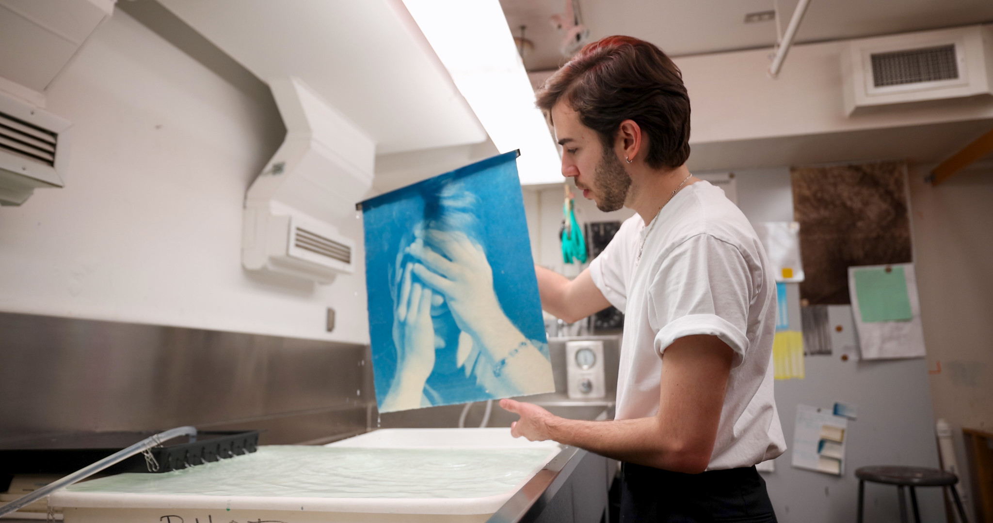 student developing an image at a work station