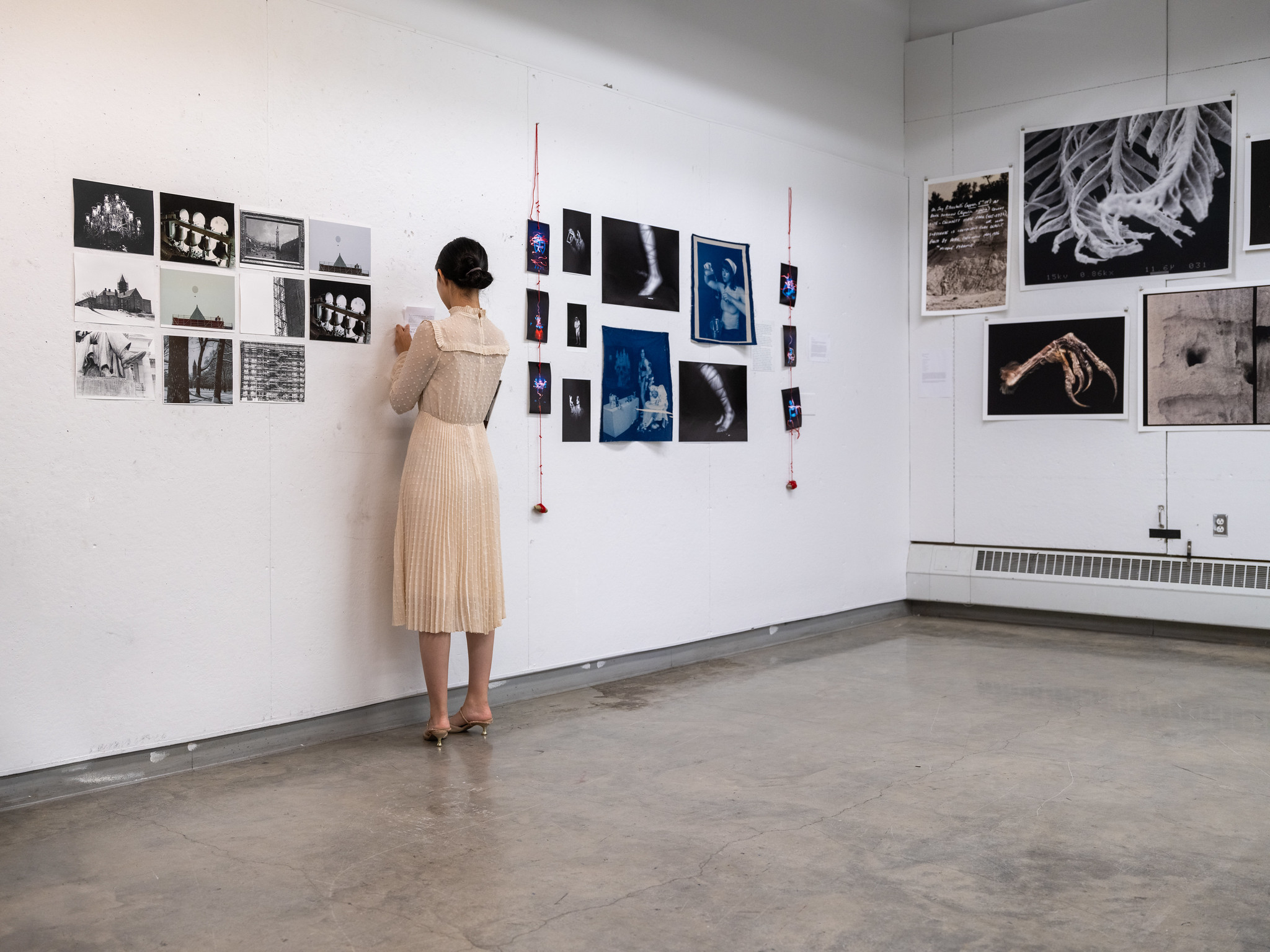 artist installing work in a gallery space