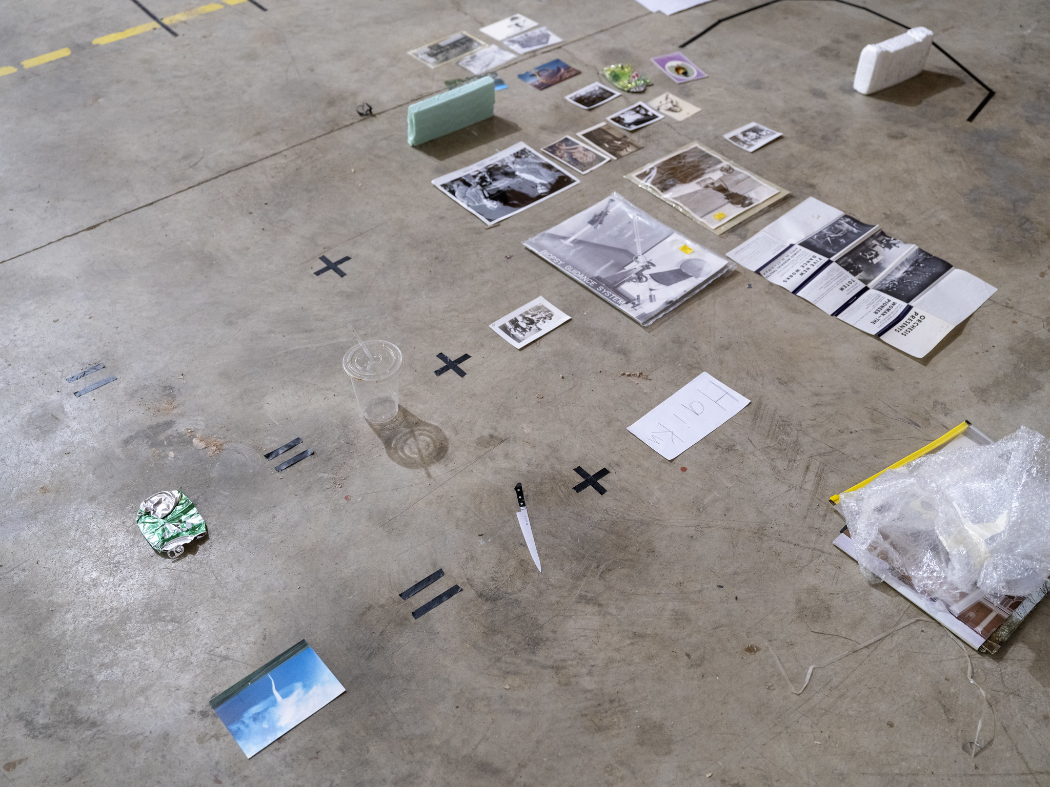 objects arrayed on a concrete floor