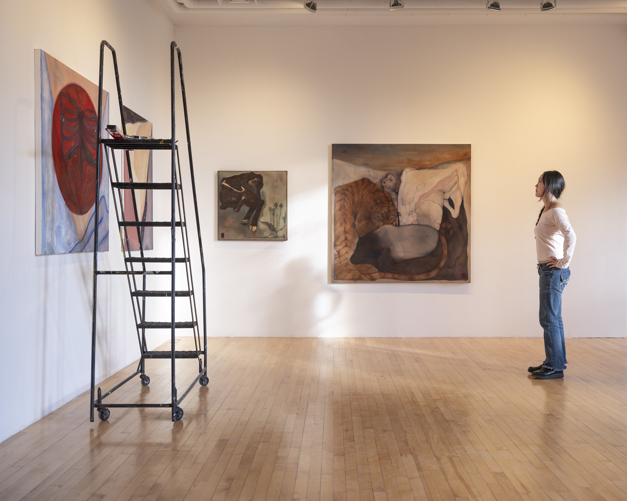 artist installing work in a gallery space