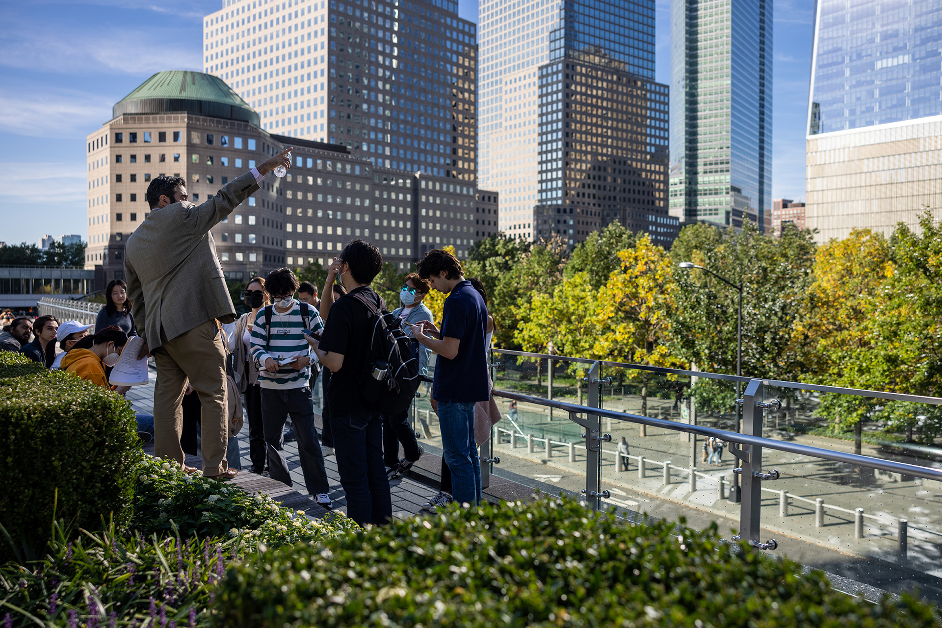 Man lecturing students on a sidewalk in lower Manhattan