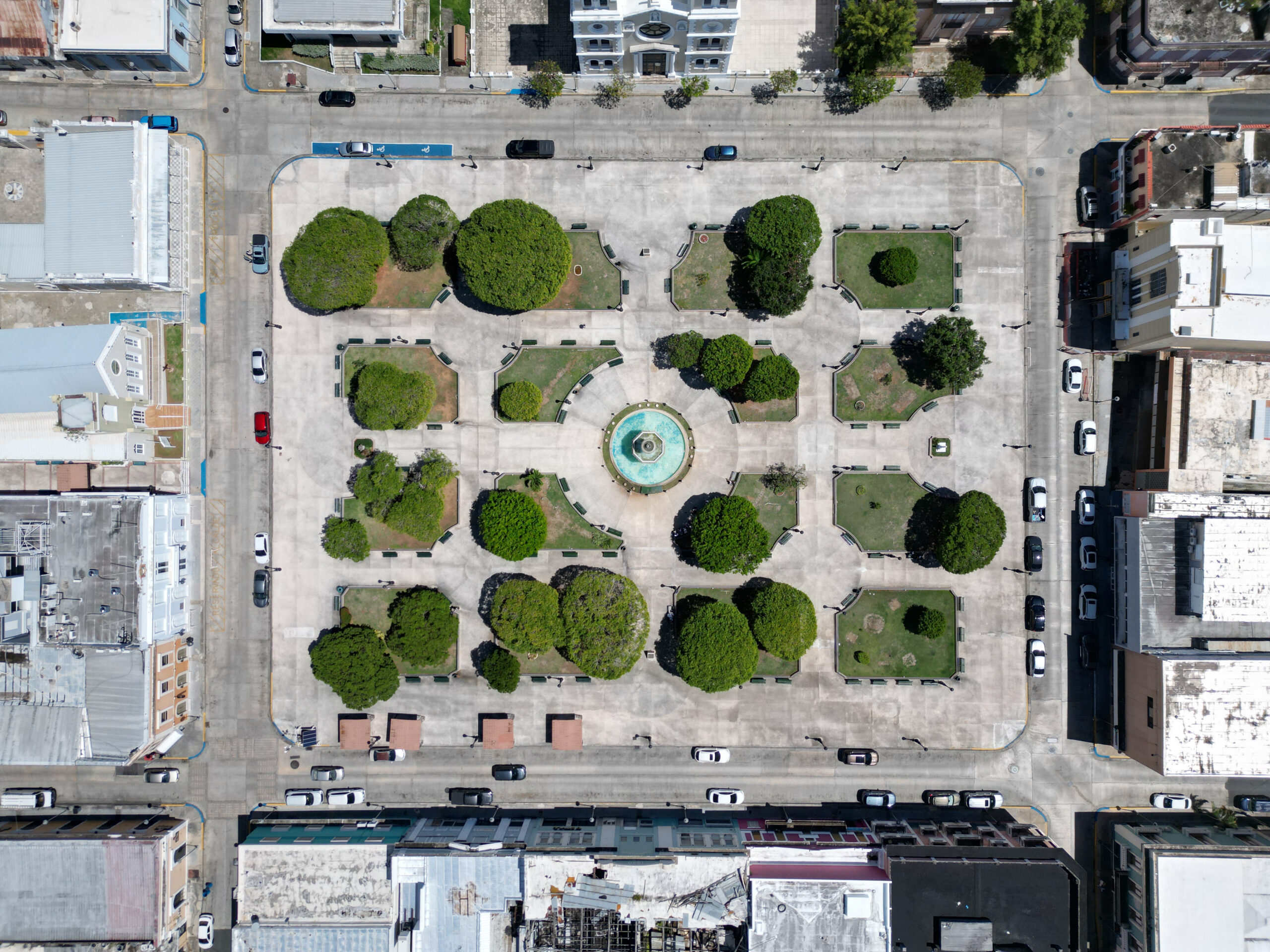 Aerial view of a city square with fountain