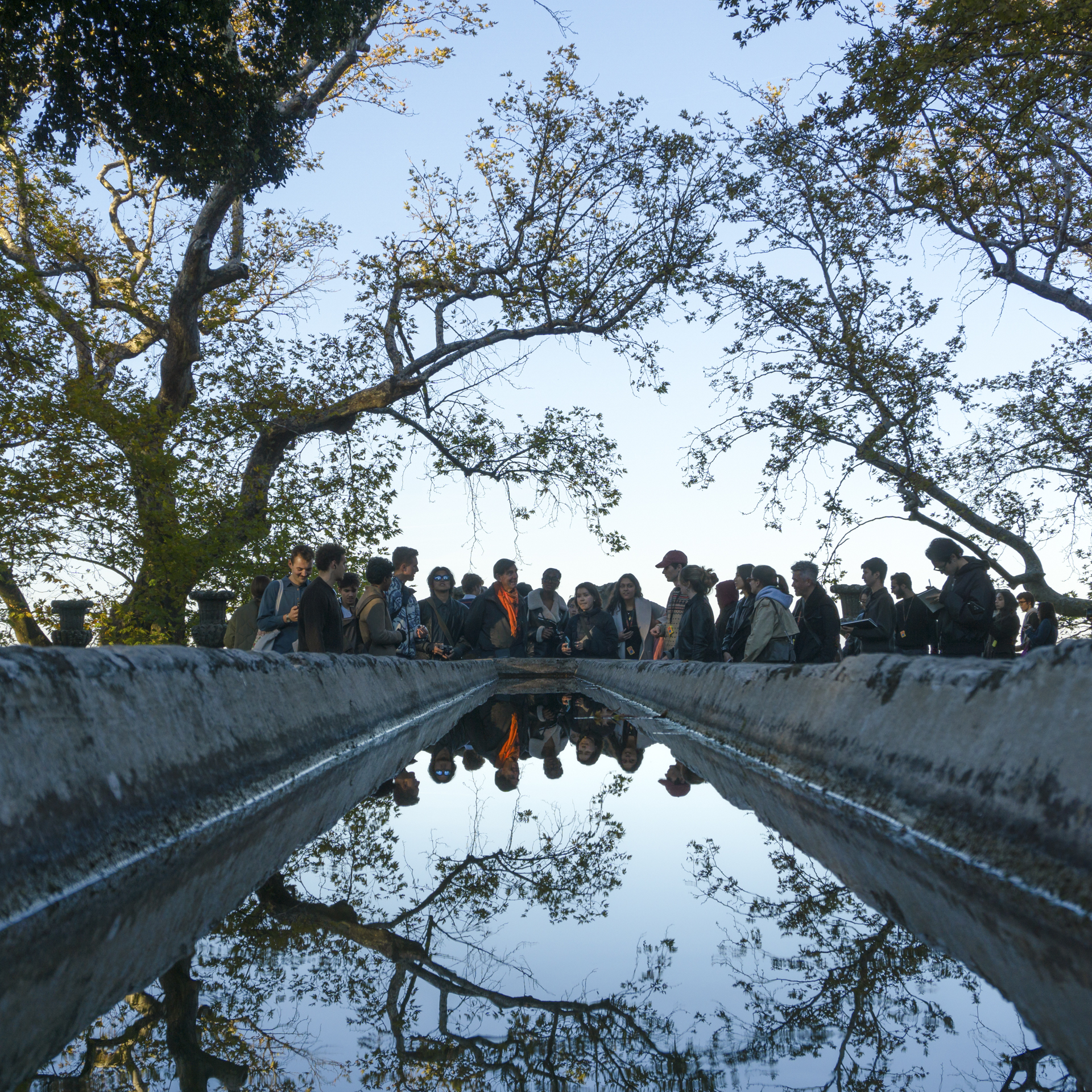 people gathered around a pool of water