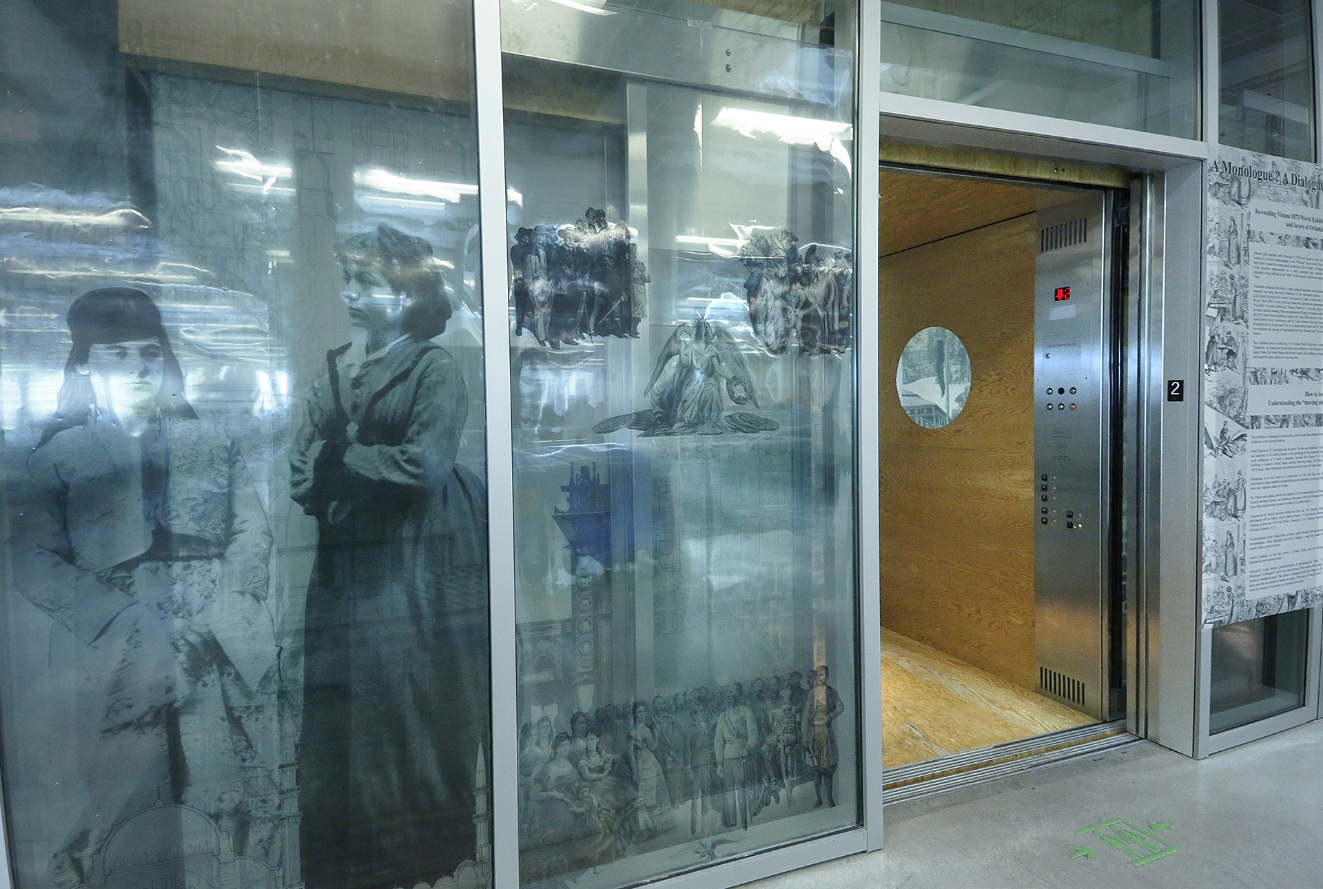 elevator with large historic images installed on front glass