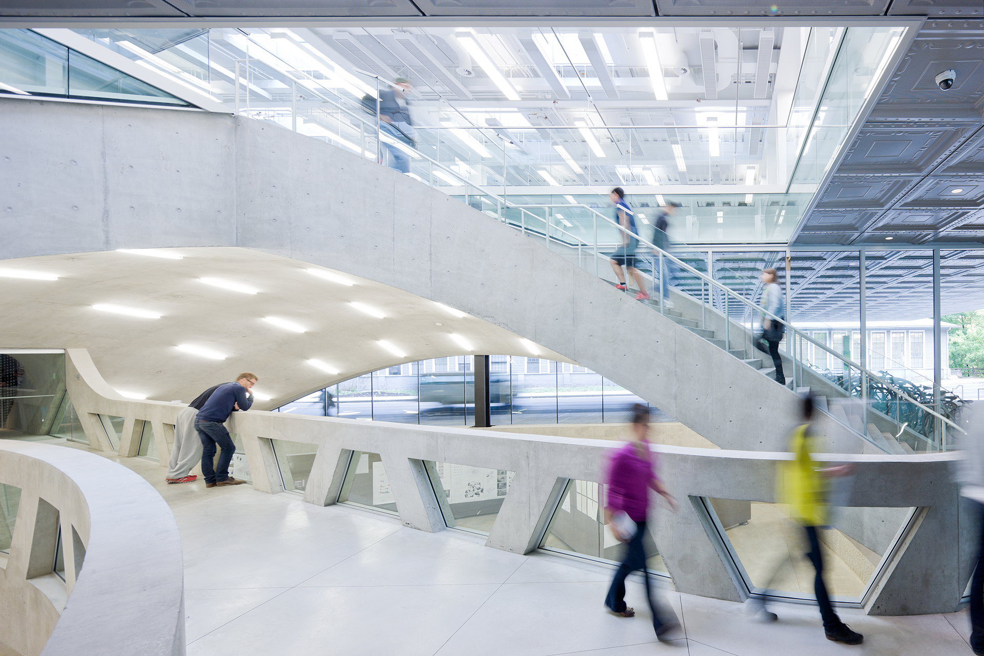 brightly lit interior concrete walkway and stairs