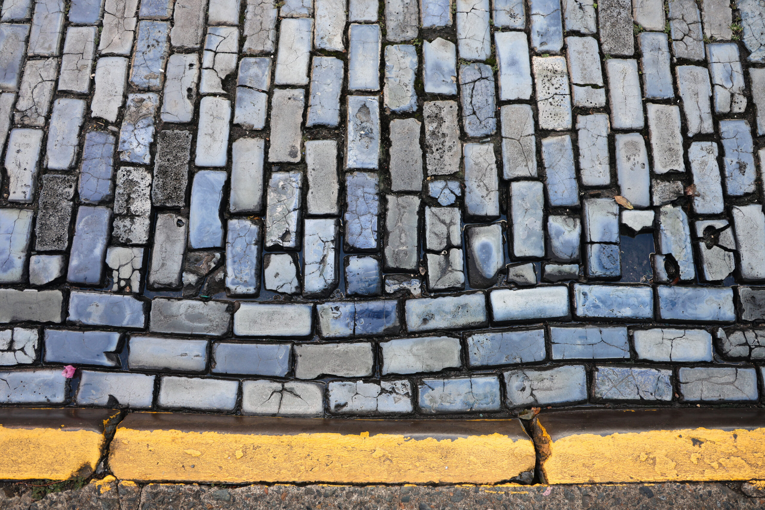 Brick street along a yellow-painted curb