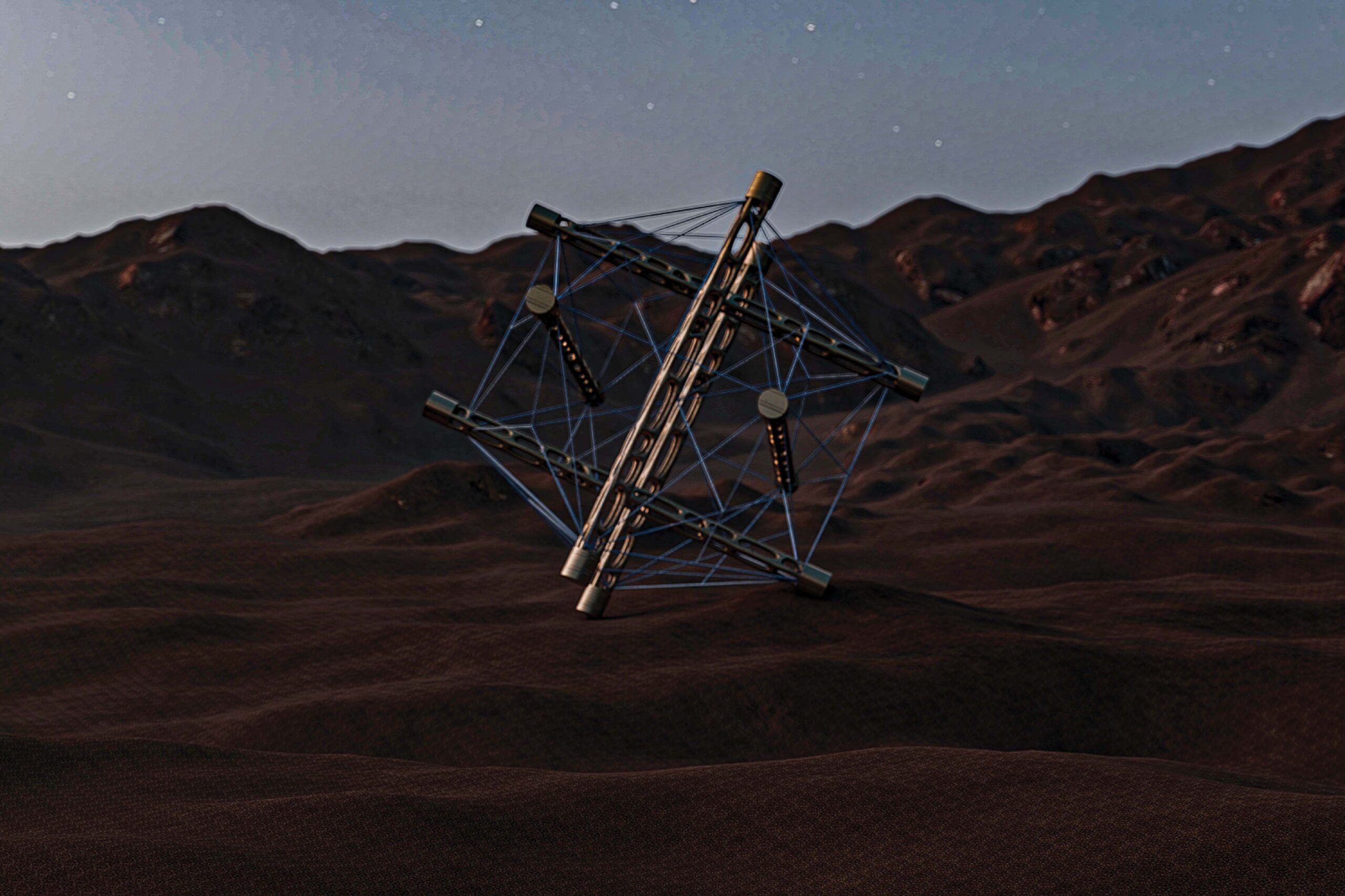 A ball-like geometric structure formed by multiple wires and metal rods tensed together, sitting on red sand desert with mountains on the horizon.