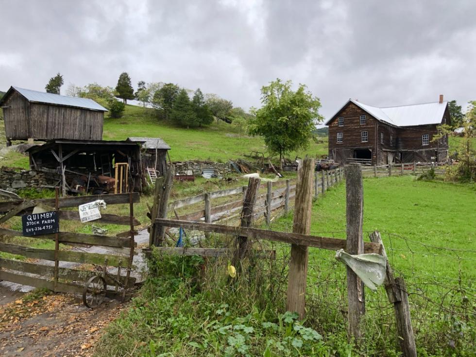 A farm with a wooden fence and a shed.