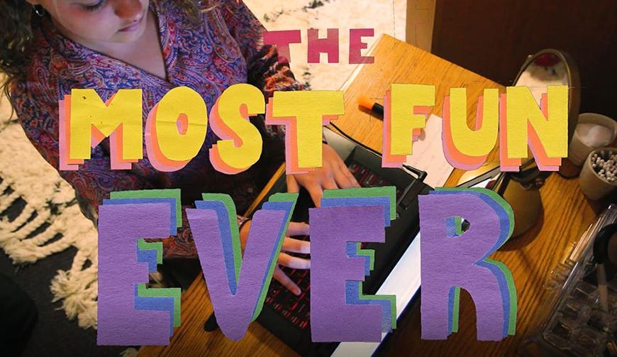 A person works on a laptop with the words 