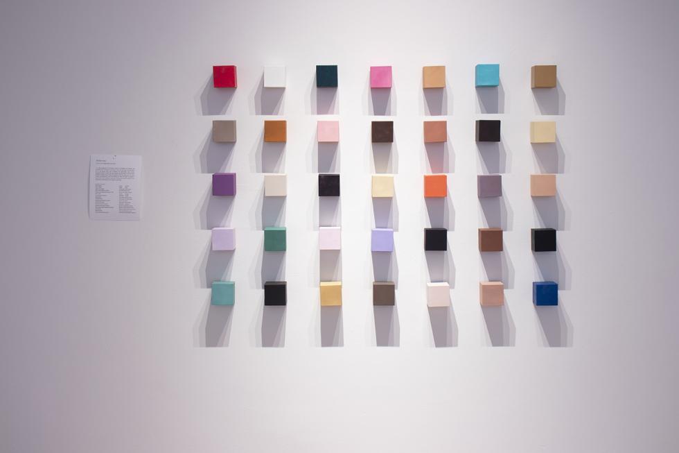 A grid of small painted canvases.