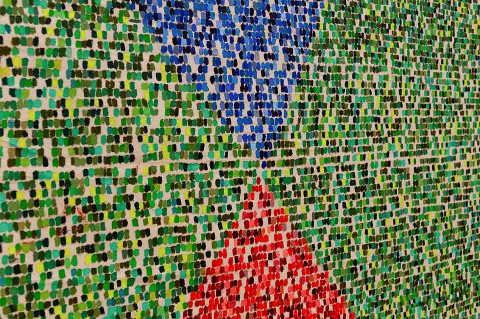 Closeup of abstract artwork featuring two triangles on a green background.