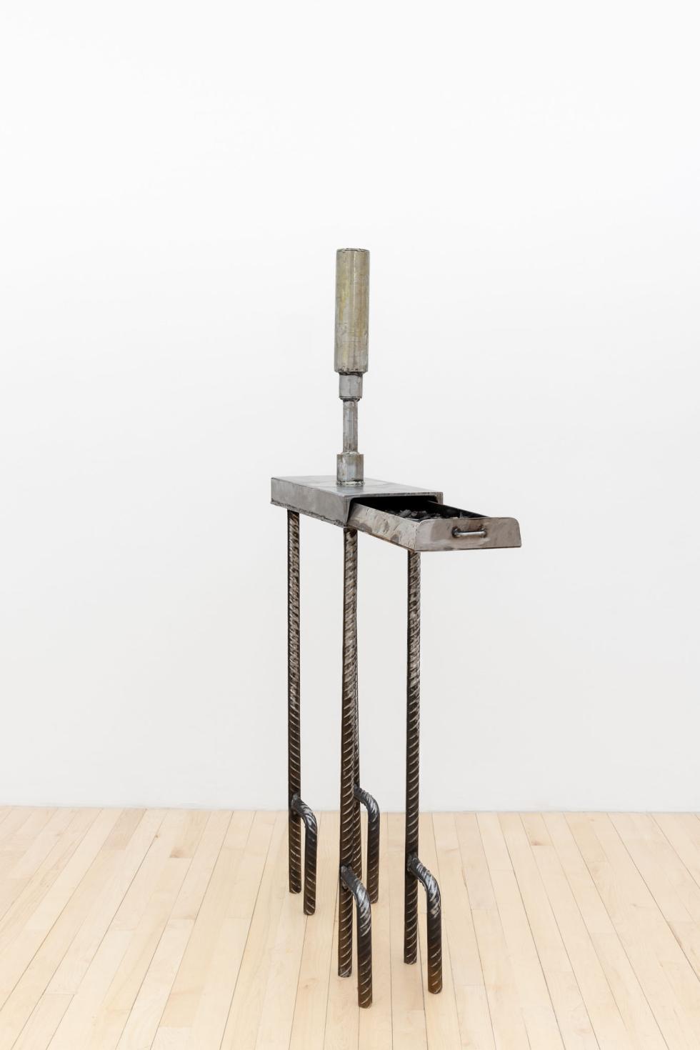 A steel table with one small drawer.