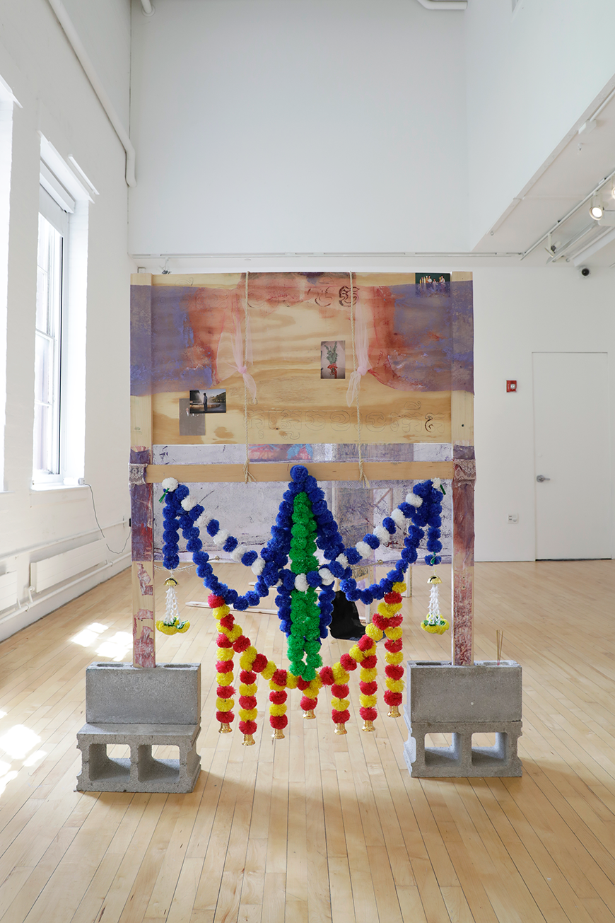 Sculpture made of wood that that is resting on cinderblocks.