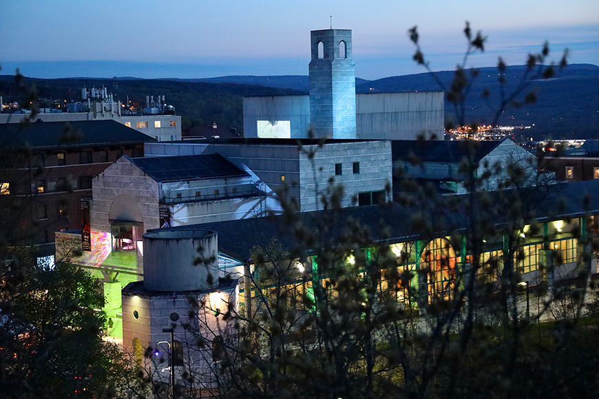 Night time outdoor scene of buildings with lights.