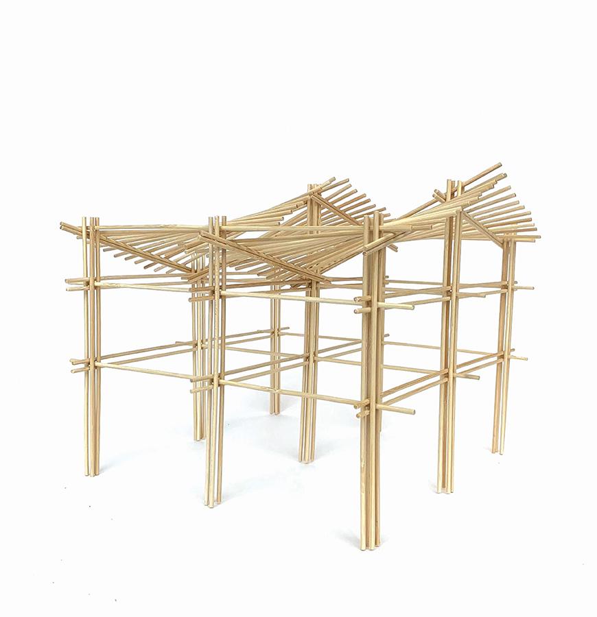 Wooden stick structure with angle roof panels.