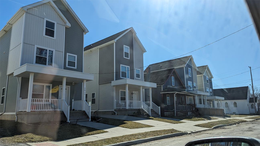 Series of multi-level homes with gray colors and porches.