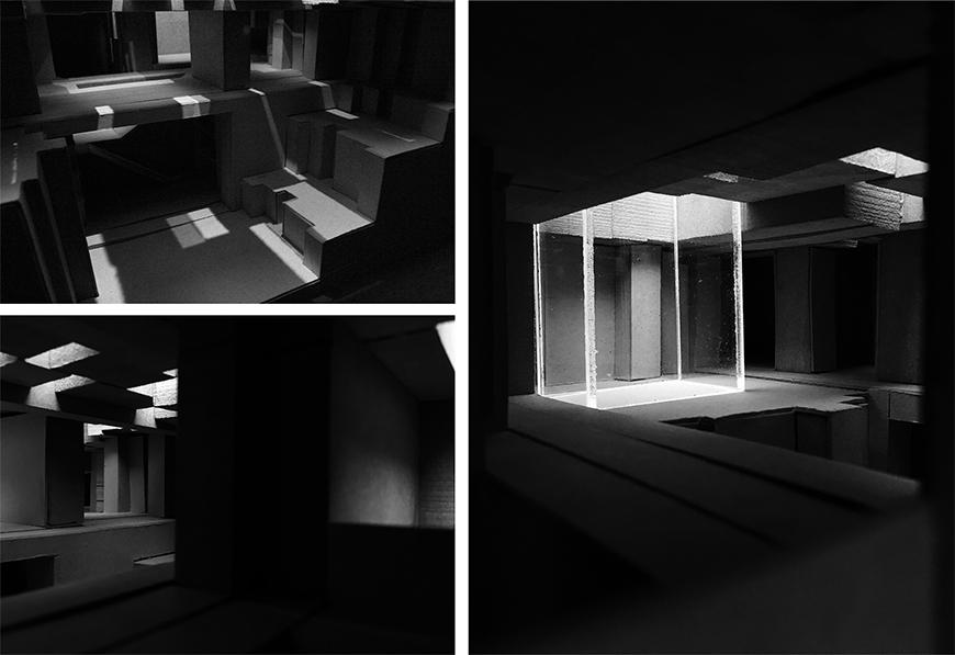 Architectural model in a dark room illuminated by a few small lights.