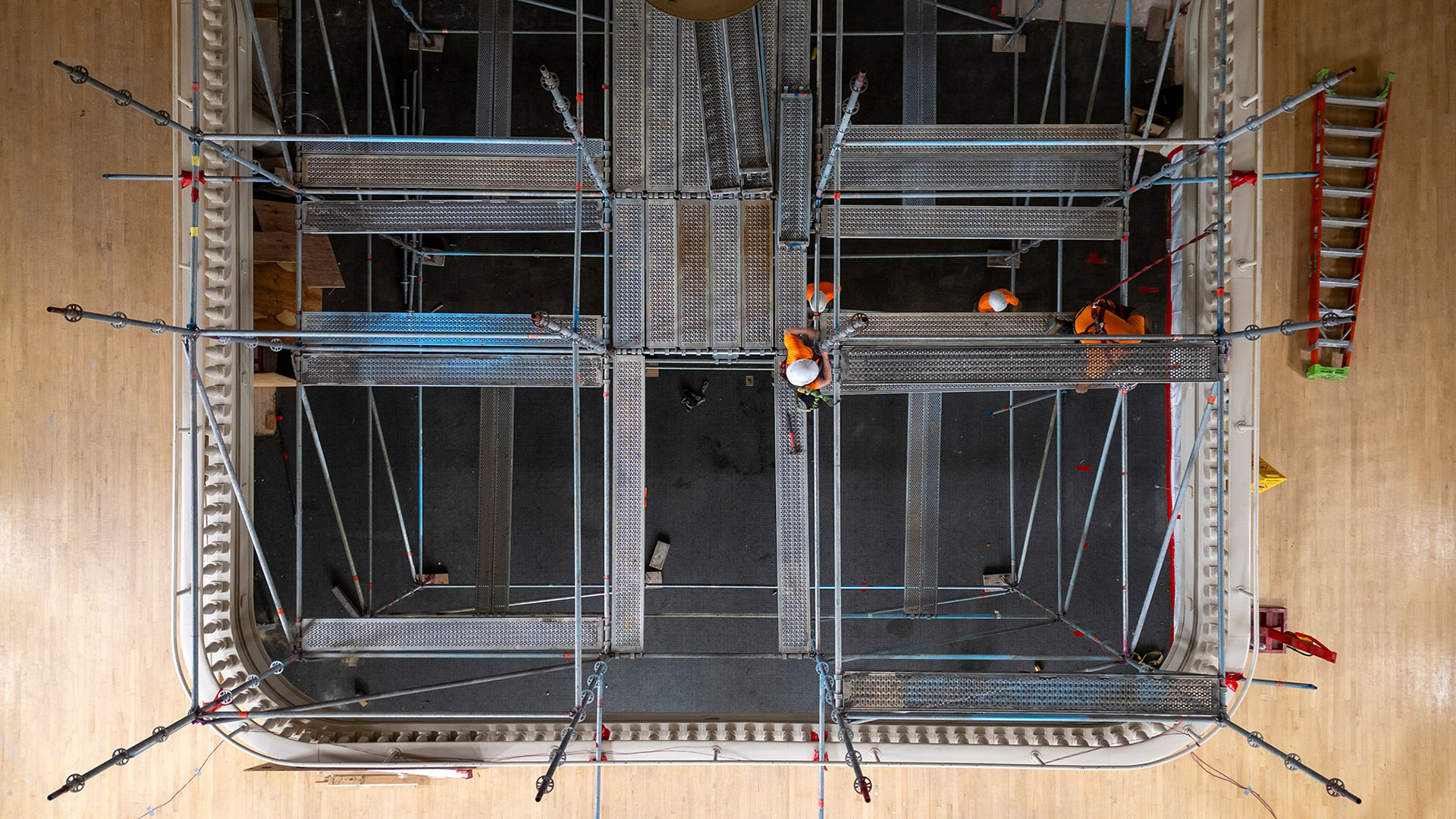 Overhead view of a balcony with metal framework and scaffolding.