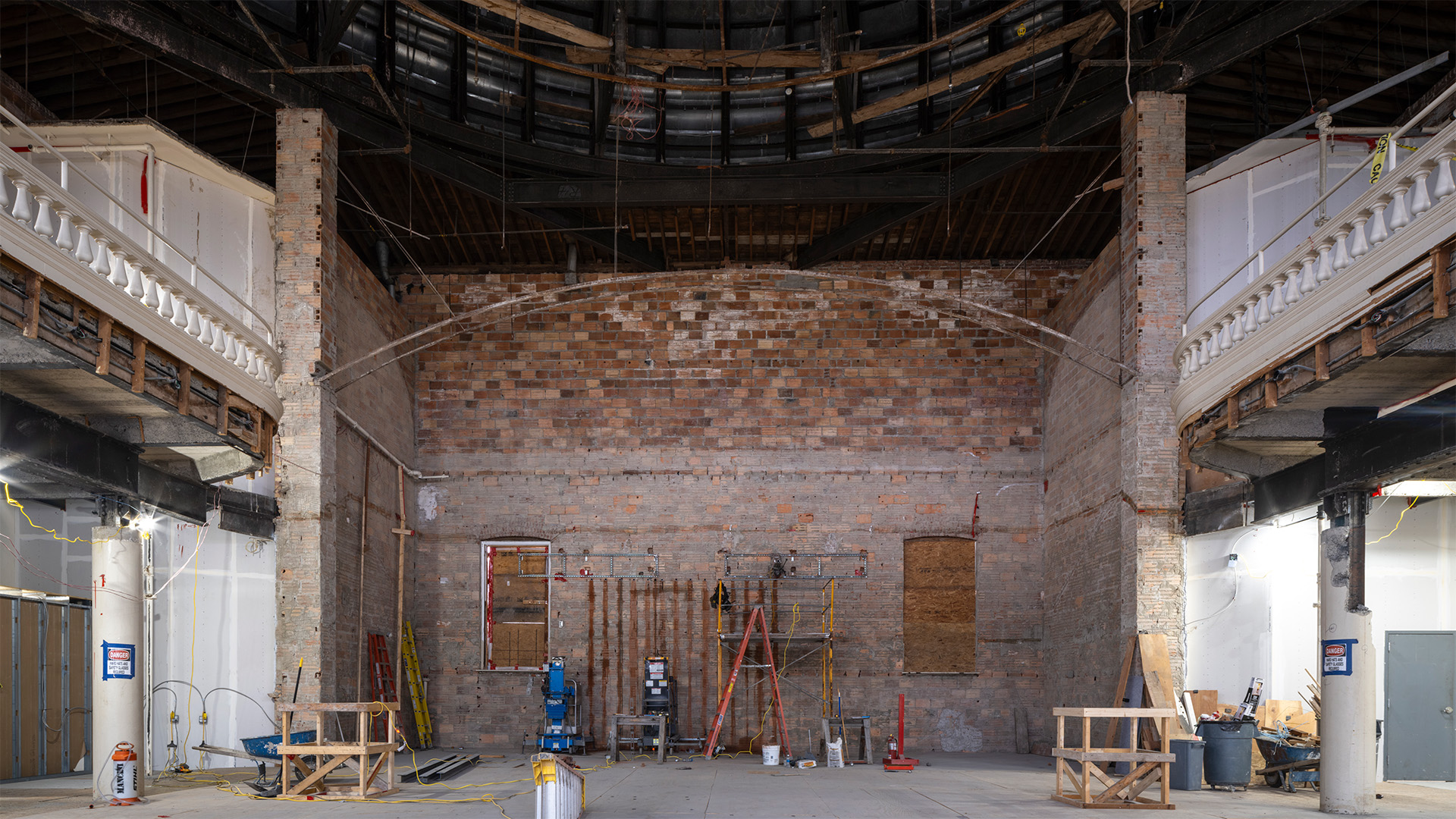 Interior of a brick walled building with balconies on either side.
