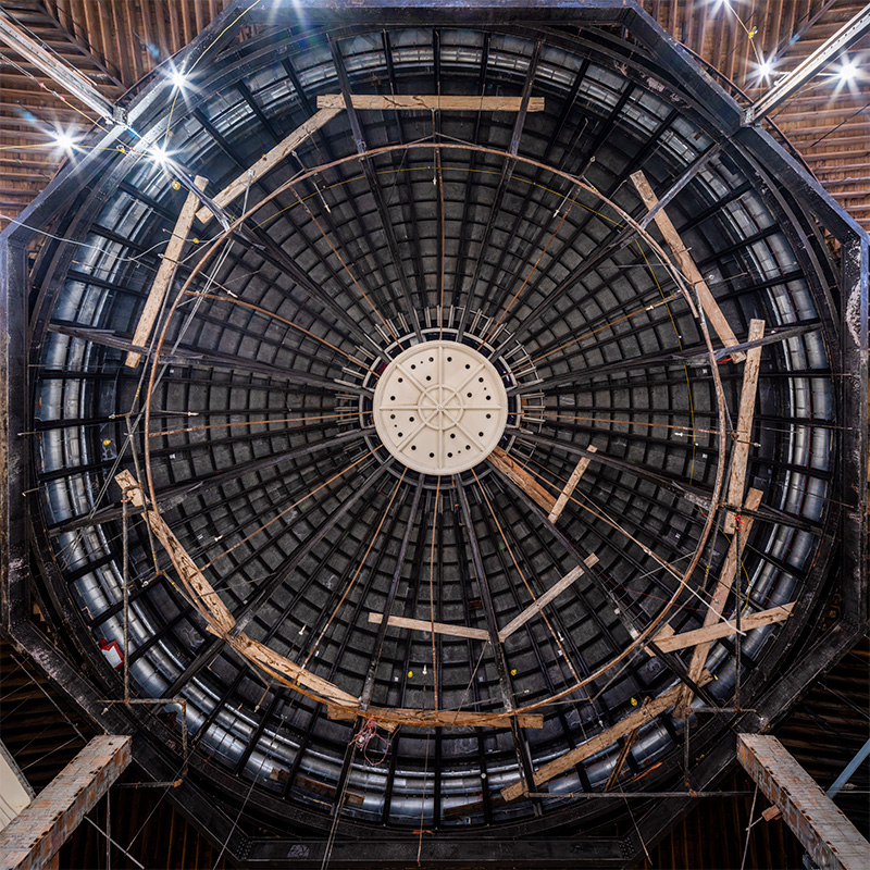 Ceiling of a domed building with wood scaffolding.