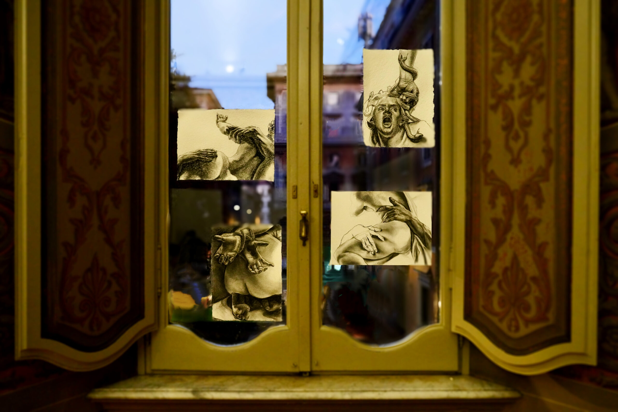 Two windows with four drawings attached to the glass panes.