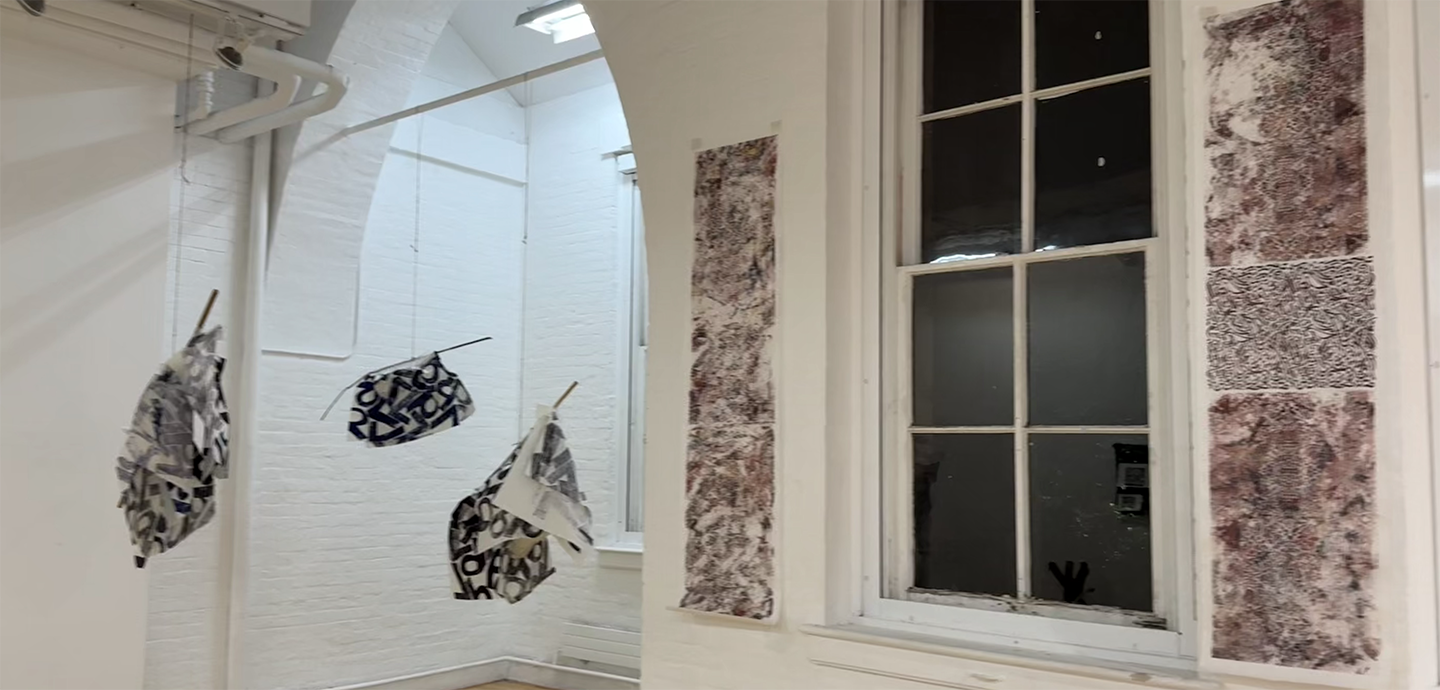 An art gallery with two printed red-brown panels on the wall