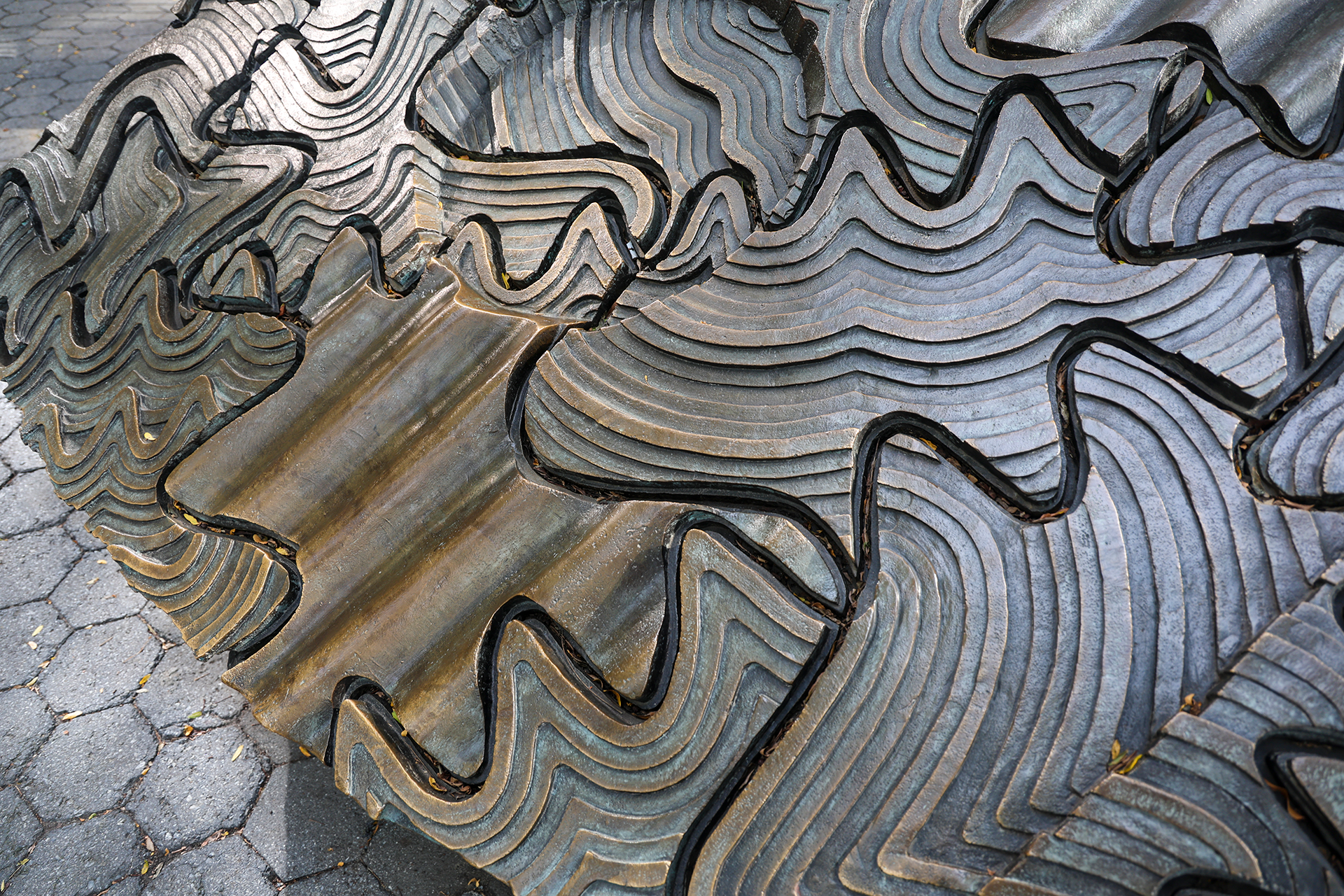 Abstract curvilinear design in bronze metal.