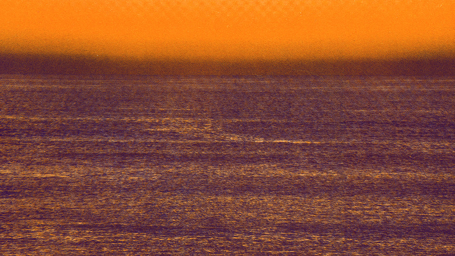 Orange tinted photograph of an ocean horizon.
