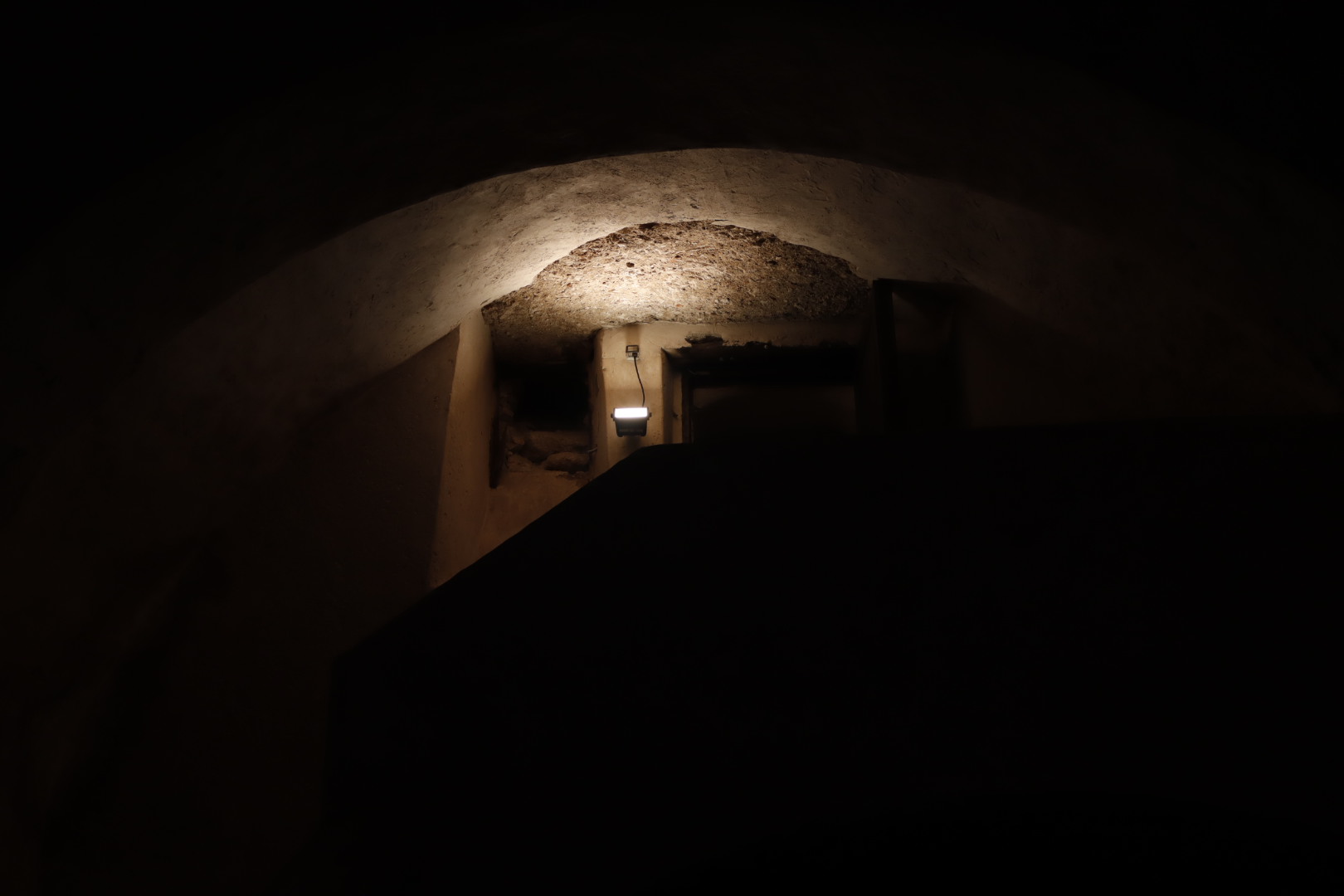 a lone light illuminating a dark room