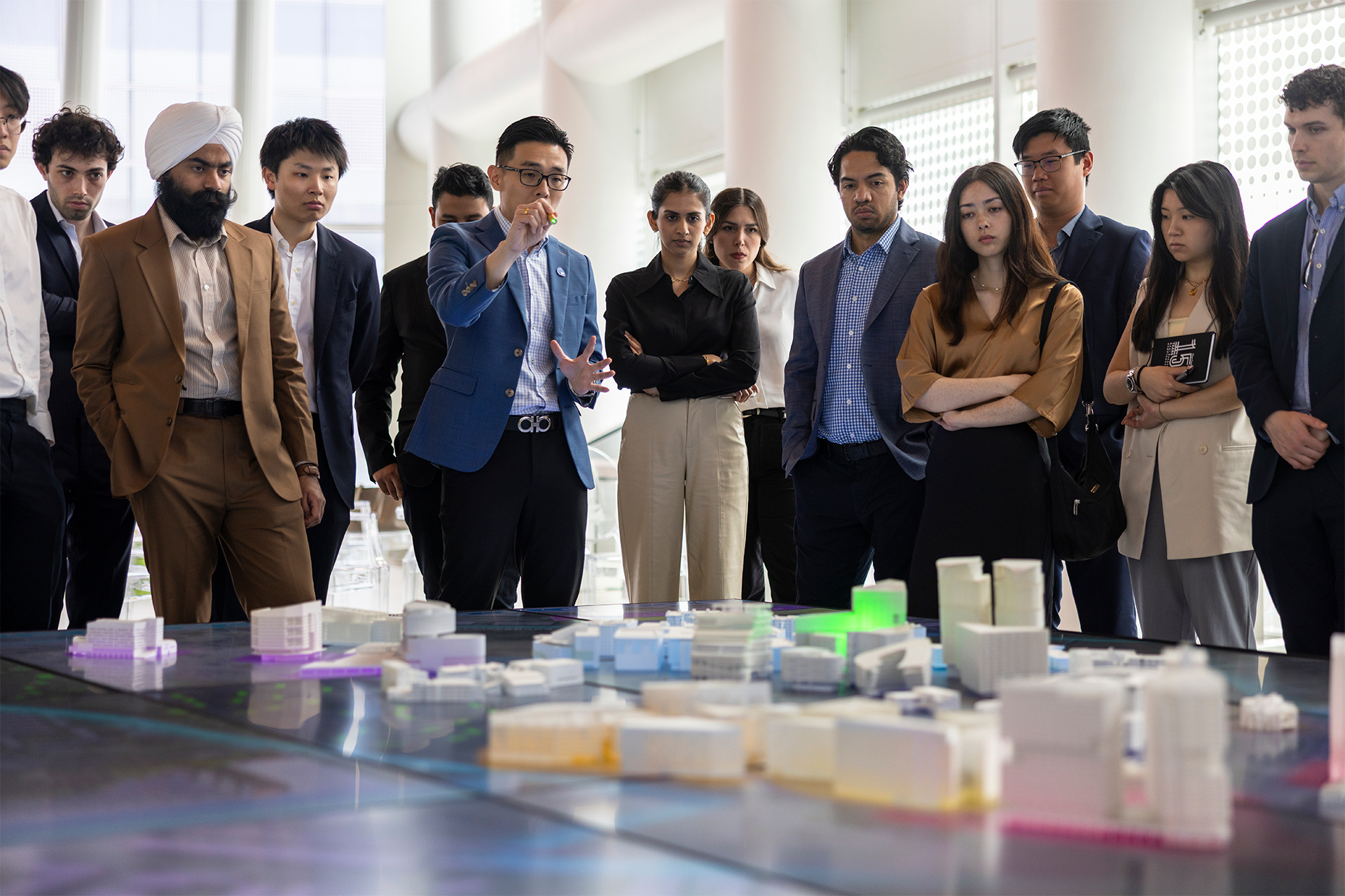 Students discuss a large city model.