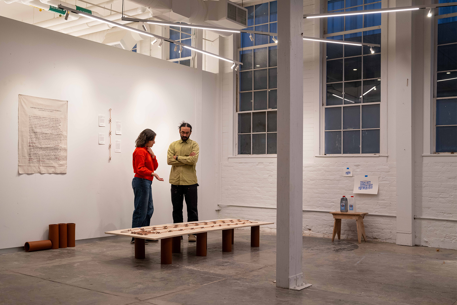 Students examining work in a gallery.