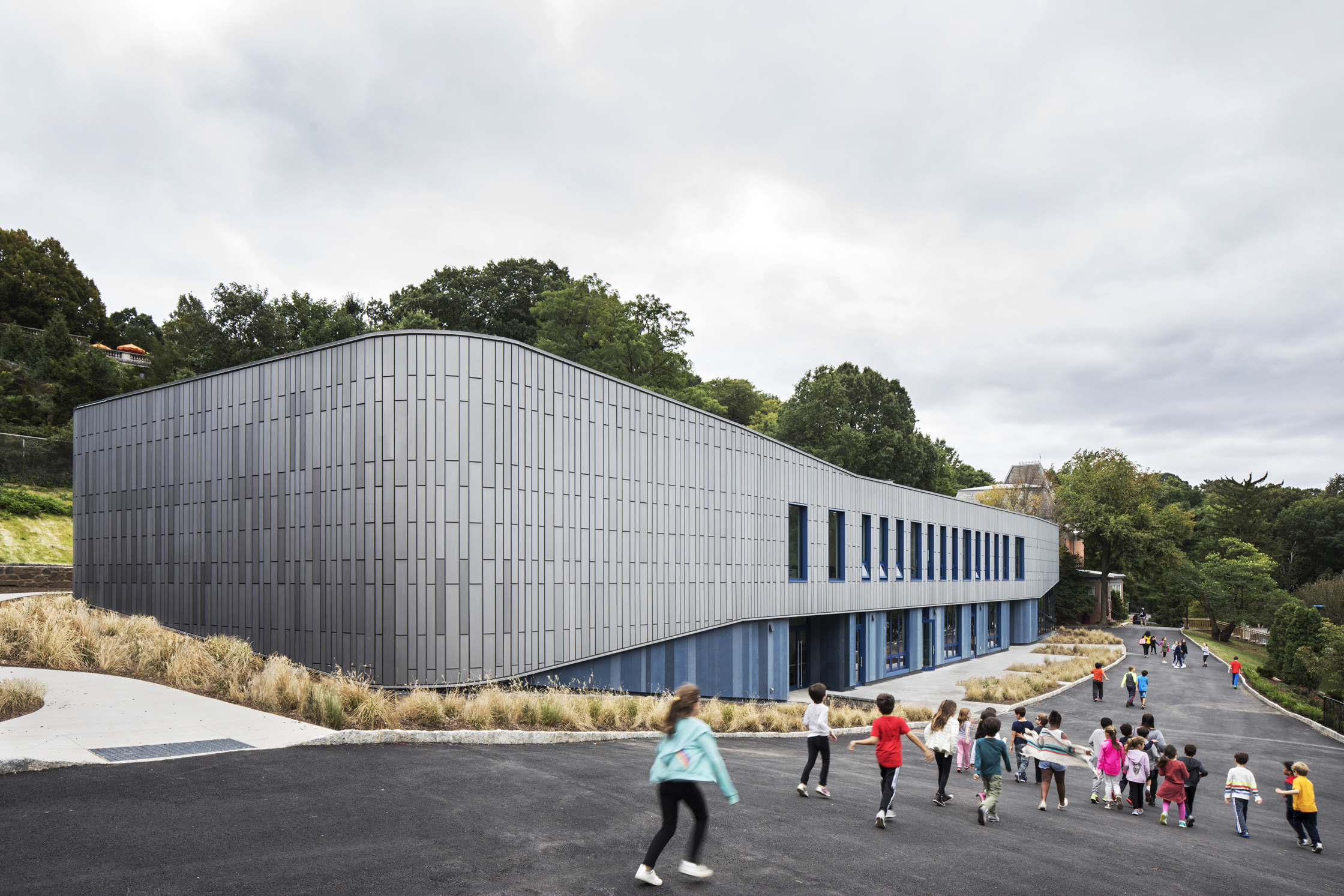 grey two-level building on a slope