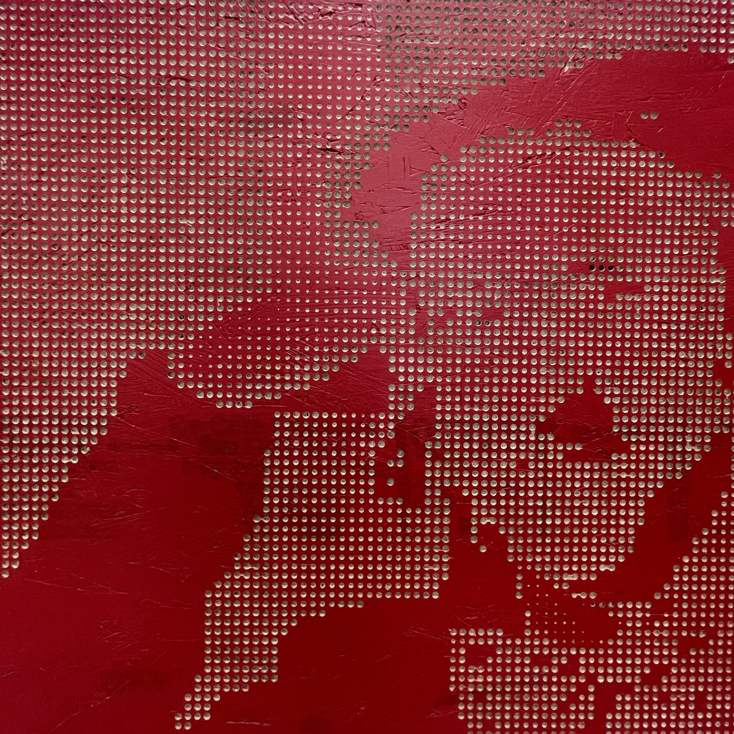 image of wooden art piece painted red with Willy Wonka face etched in