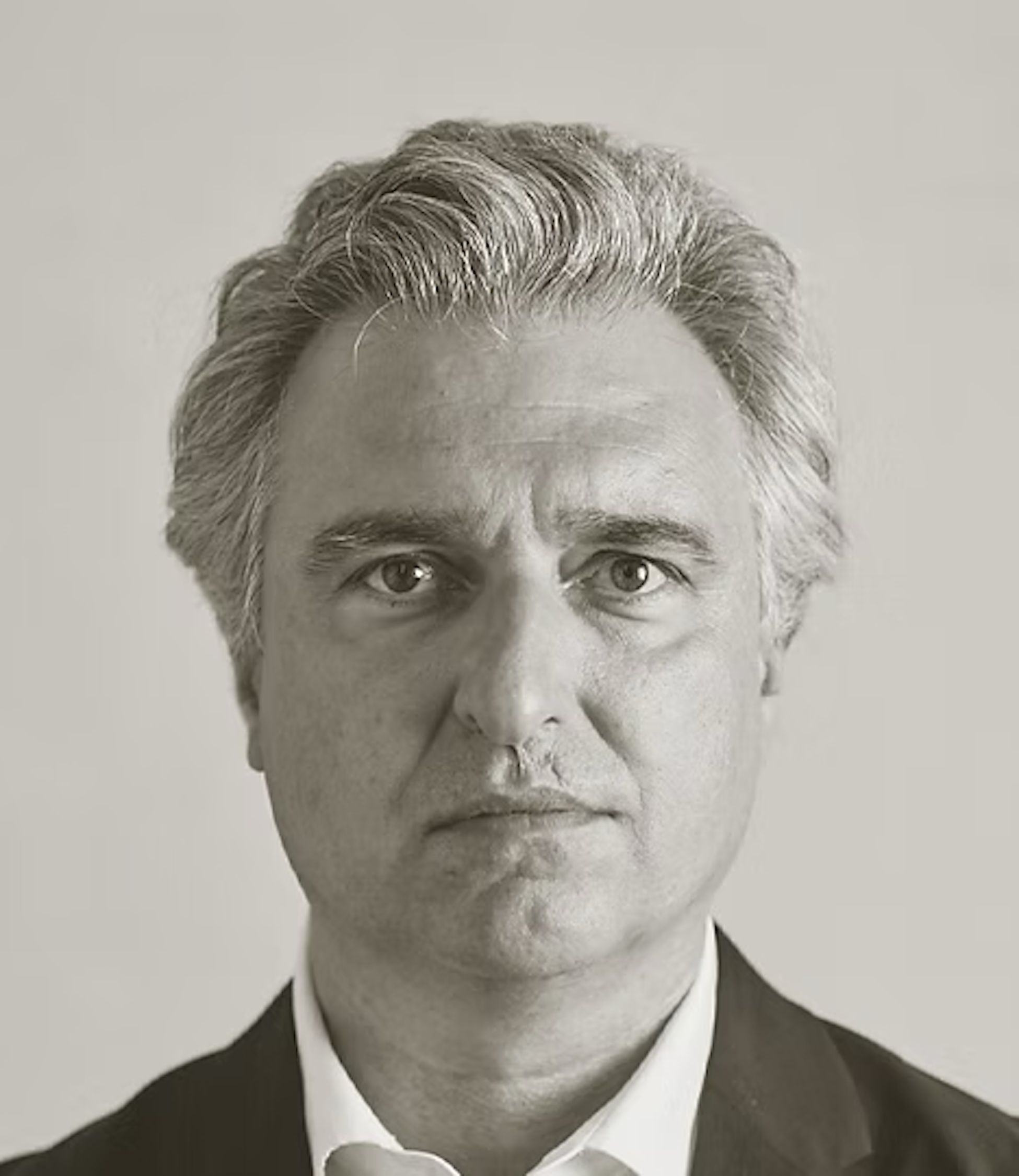 A monochrome, close-up headshot of Antón García-Abril featuring a neutral expression and swept-back graying hair against a plain background.