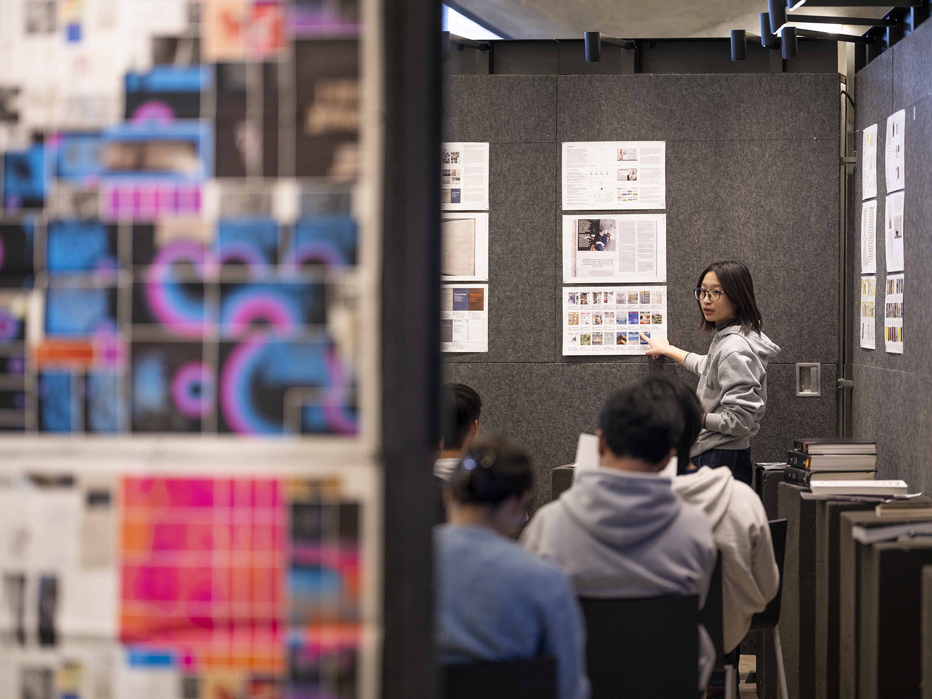 Student presenting pinned up work.