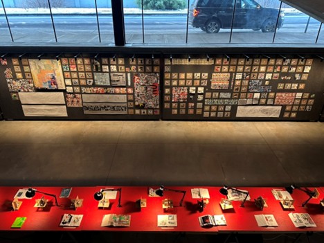 downward looking photo of an exhibition of collage works