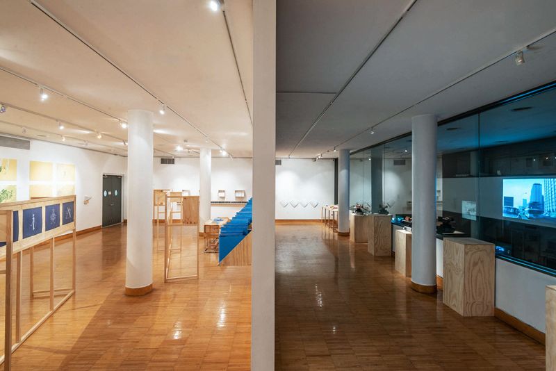 a white walled gallery with shiny wooden floors