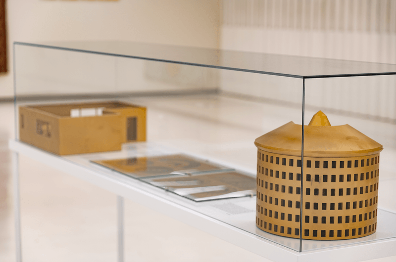 two architectural models in a display case
