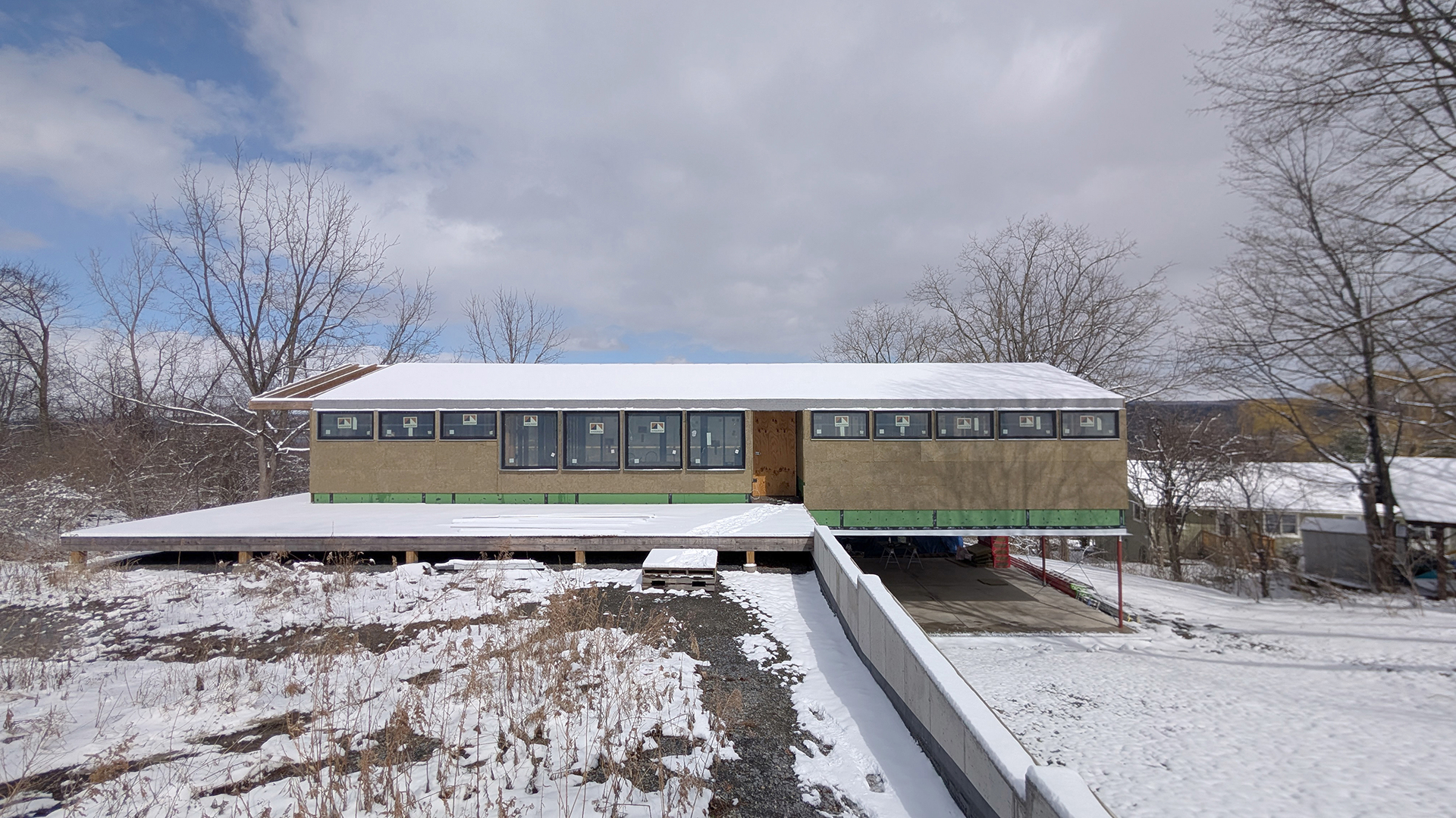 house under construction covered in light snow
