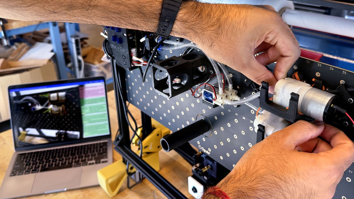 A close up of a person's hands as they work on a machine.