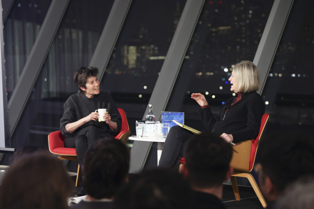 two people speaking on stage