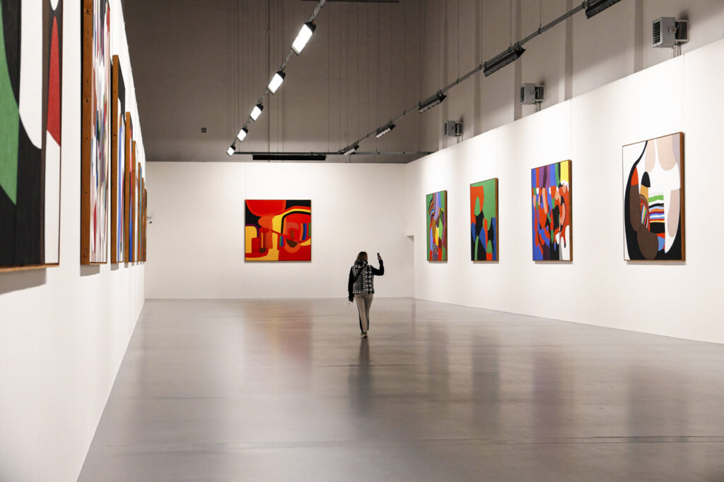 person walking through gallery space