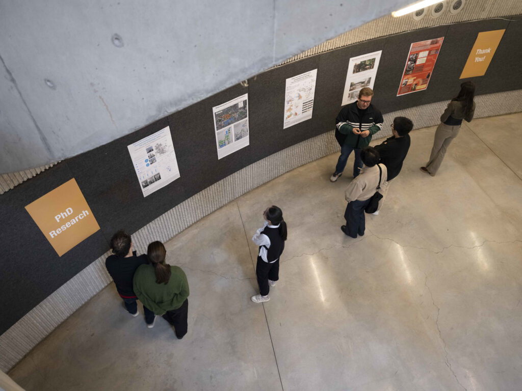 people examining wall-mounted posters