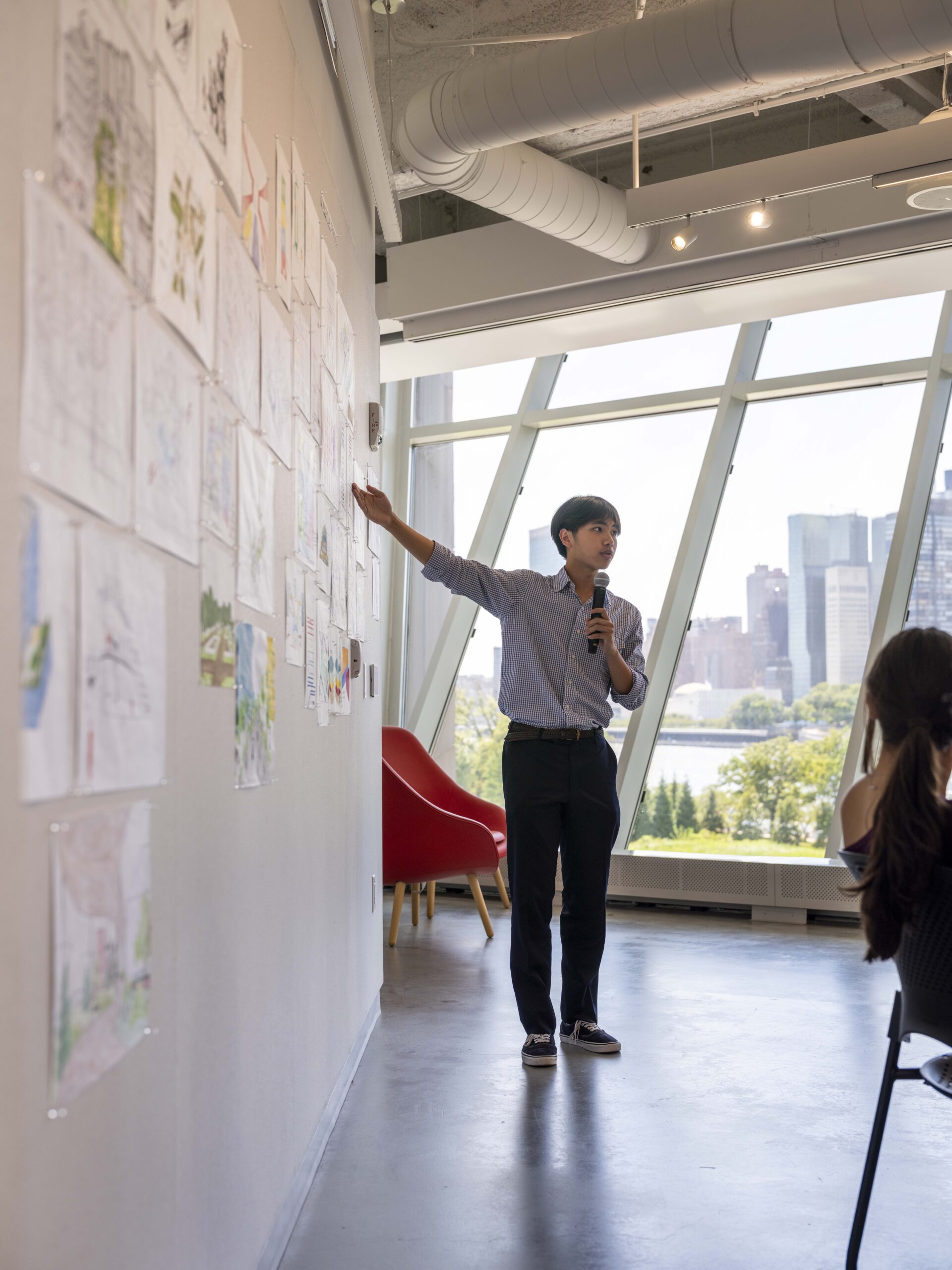 A person presenting a pin-up presentation of sketches