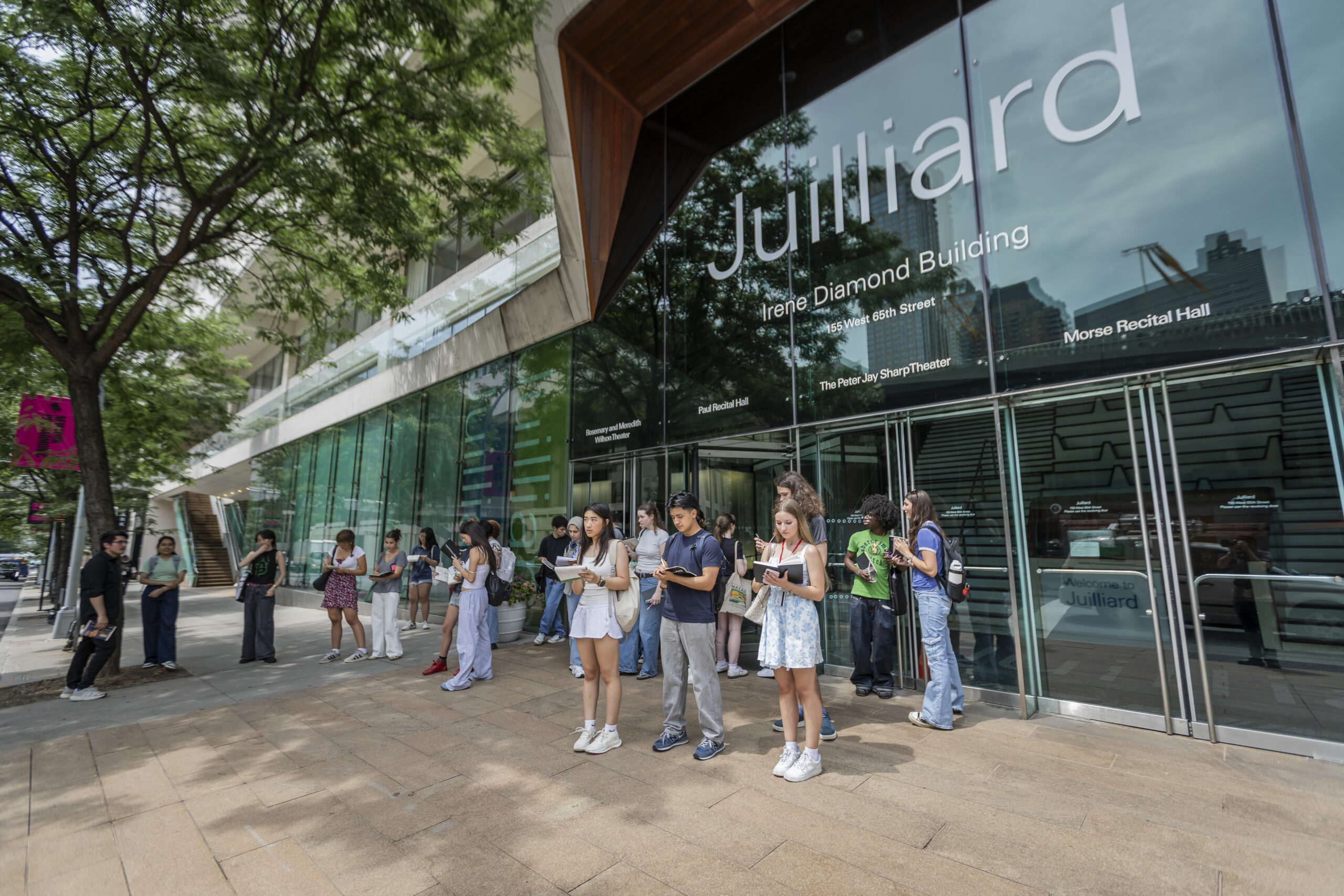 People standing in front of Julliard sketching